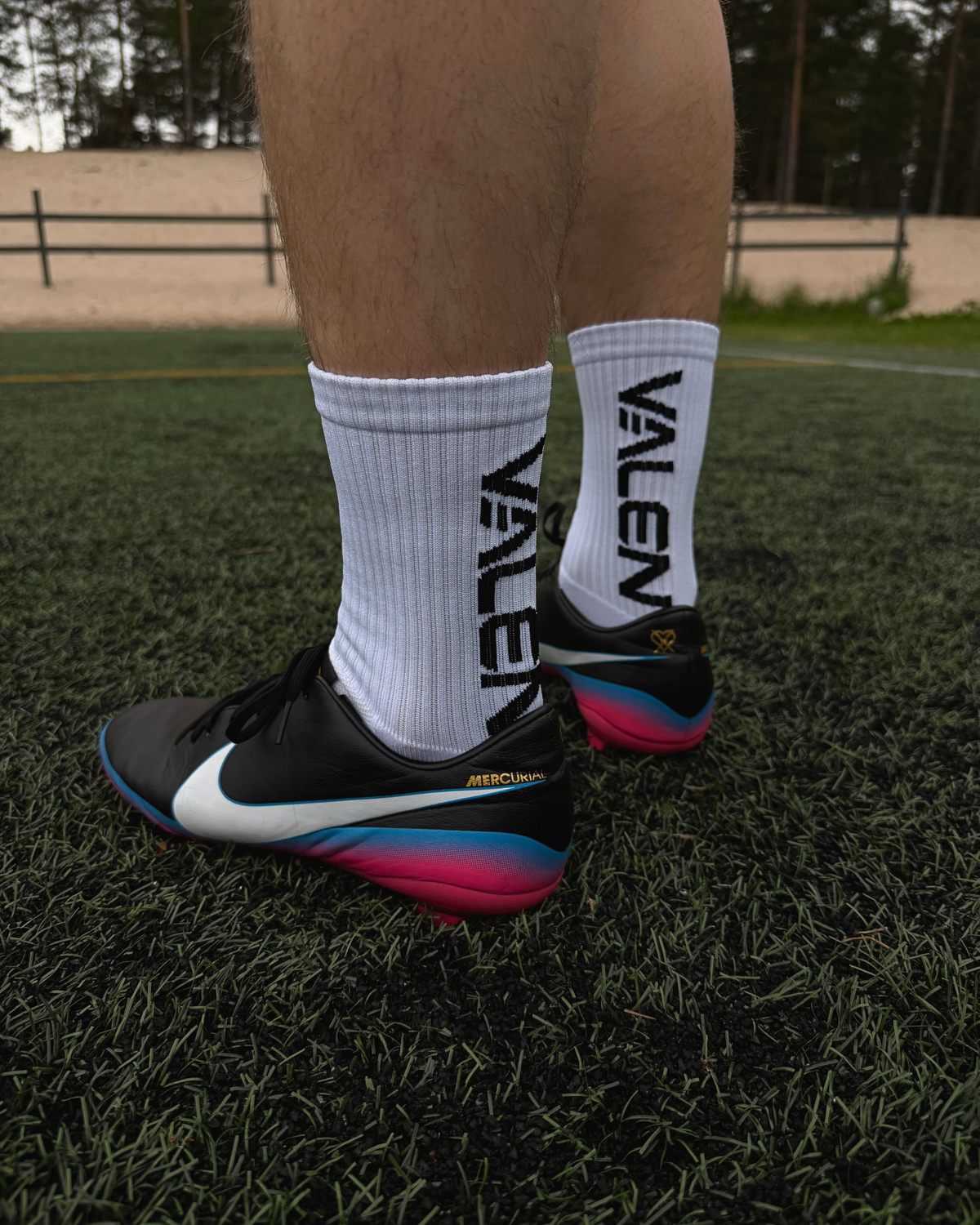 VALEN grip socks and cleats on a football pitch
